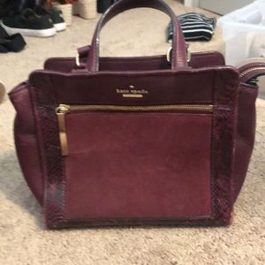 Maroon Kate Squad Medium sized crossbody purse.